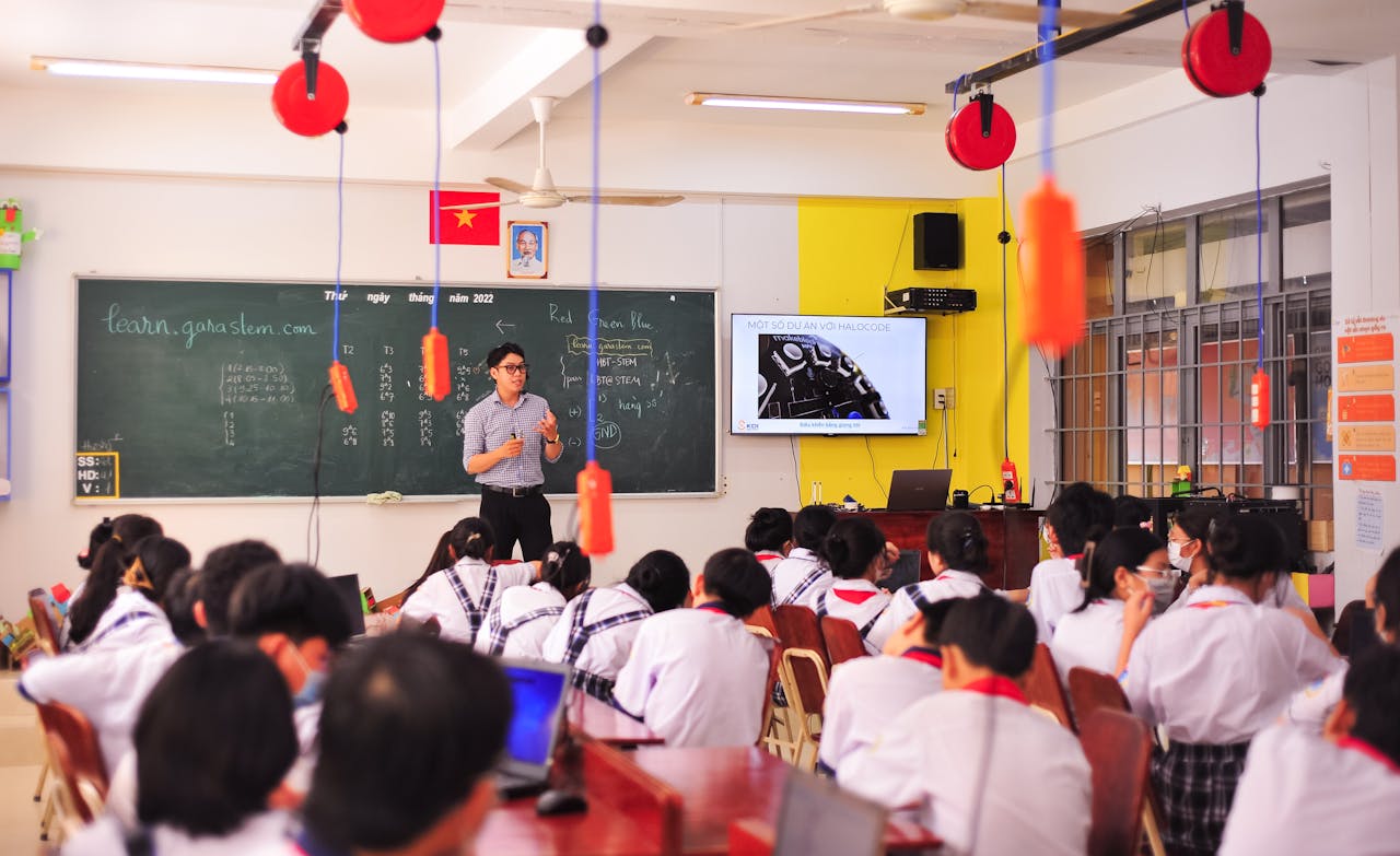 Teacher conducts an interactive lesson in a vibrant classroom setting with attentive students.